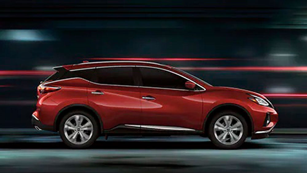 2023 Nissan Murano shown in profile driving down a street at night illustrating performance. | Natchez Nissan in Natchez MS