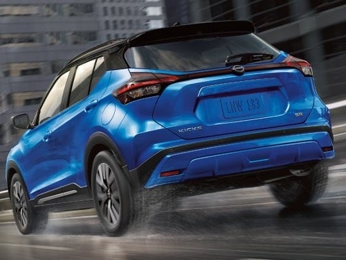 2024 Nissan Kicks rear view of vehicle driving down road