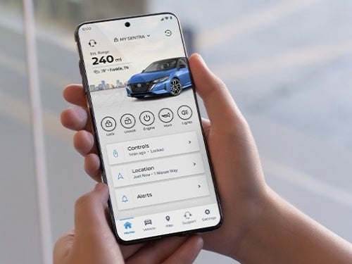 2024 Nissan Sentra view of person holding phone with MyNISSAN App shown