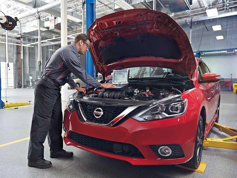 Nissan mechanic inspecting a vehicle